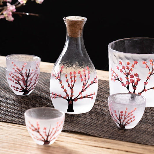 Glass Japanese sake set with cherry blossom design, tokkuri bottle, cups and warmer